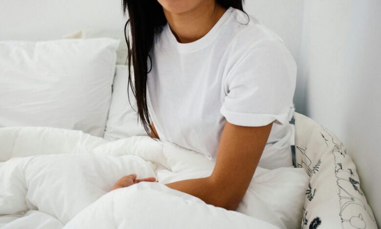 woman sitting on bed